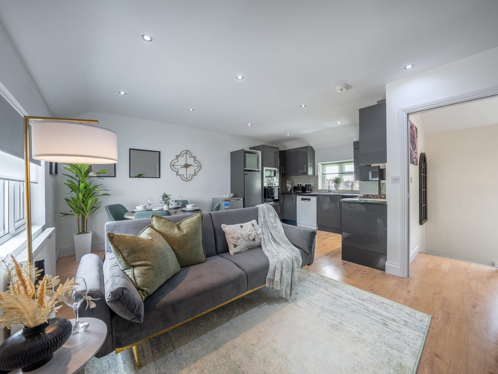 The furnished open-plan living room and kitchen of a West Drayton property, ready for tenants